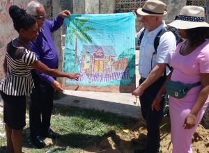Mark working for the The Queen Elizabeth II, Platinum Jubilee Commonwealth Heritage Skills Training Programme, was presented with a beautiful piece of batik fabric produced by children at Grantley Adams Memorial School school